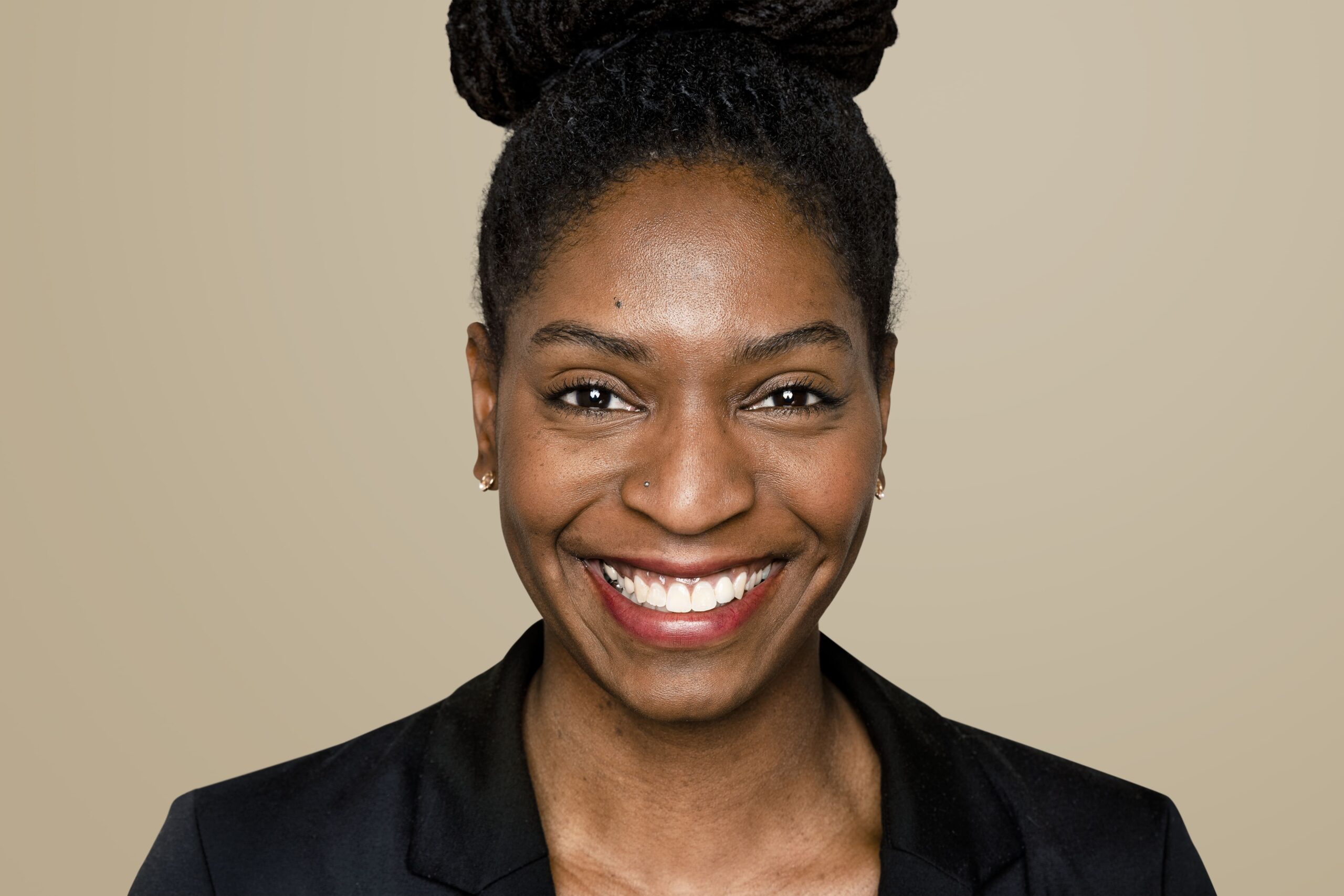 african-american-woman-smiling-beige-background (1)
